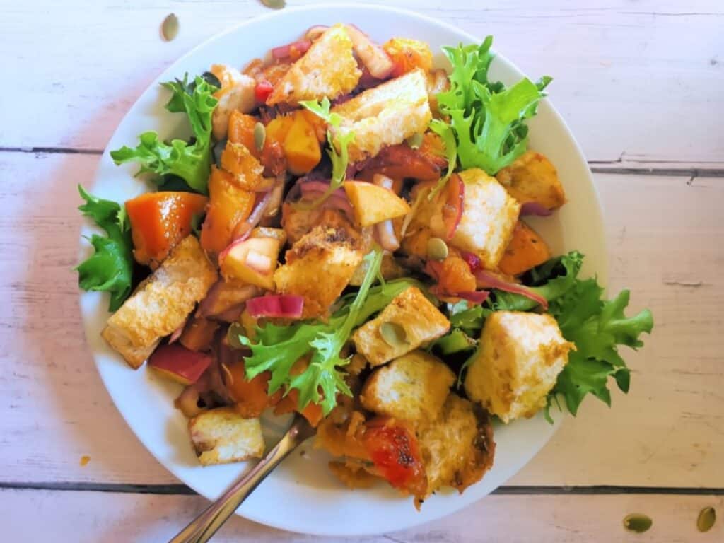 butternut squash casserole vegetarian recipe on a bed of greens