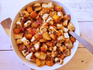 butternut squash casserole in a white serving bowl