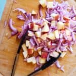 onion and apple on a cutting board