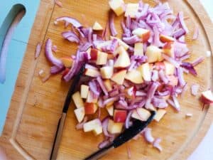 onion and apple on a cutting board