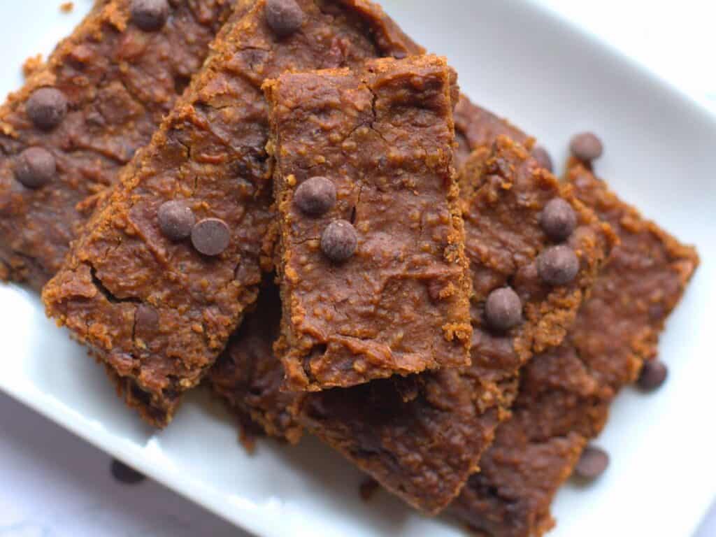 fudgy brownie bars piled on a white plate