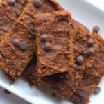fudgy brownie bars piled on a white plate