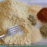 bread crumbs being mixed with spices
