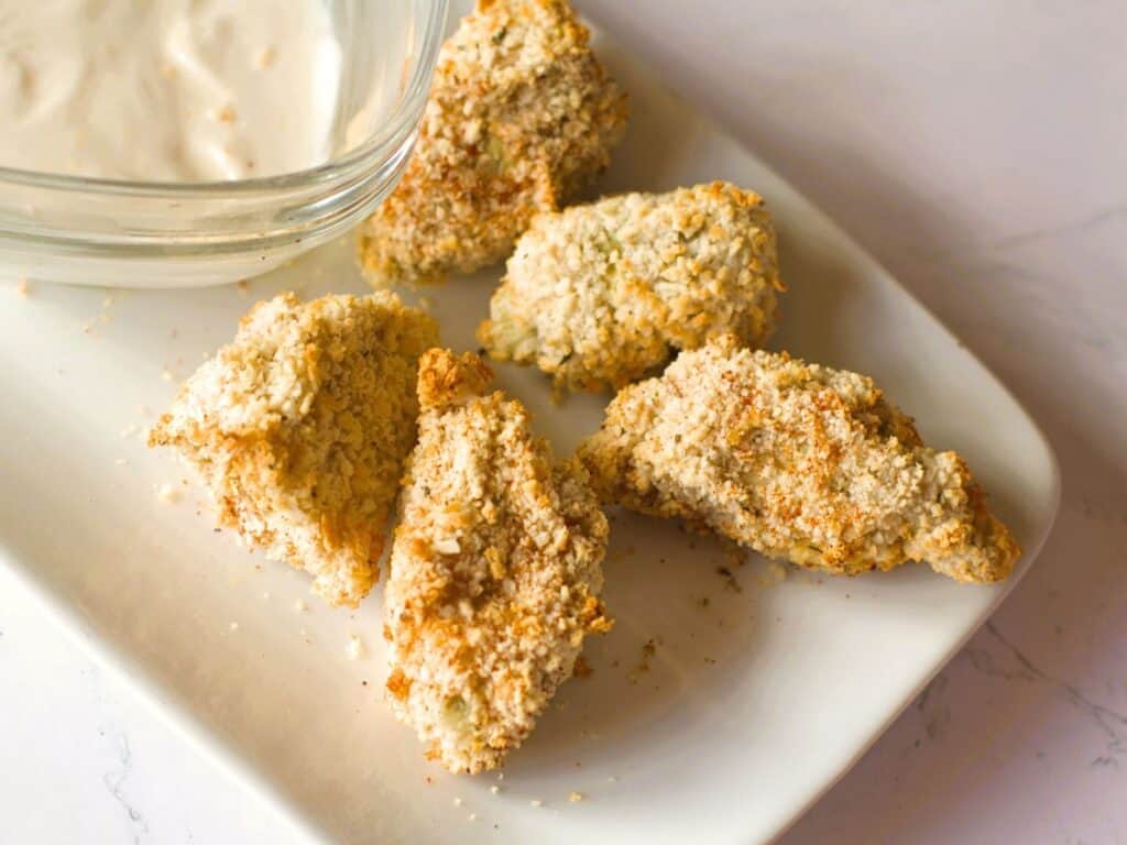 air fried artichokes on a plate with dipping sauce