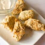 air fried artichokes on a plate with dipping sauce