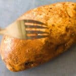 a fork being poked into a potato