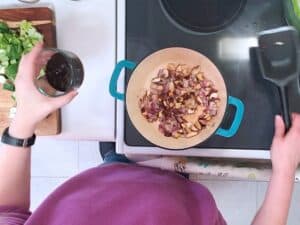black bean sauce added to a pot of onions