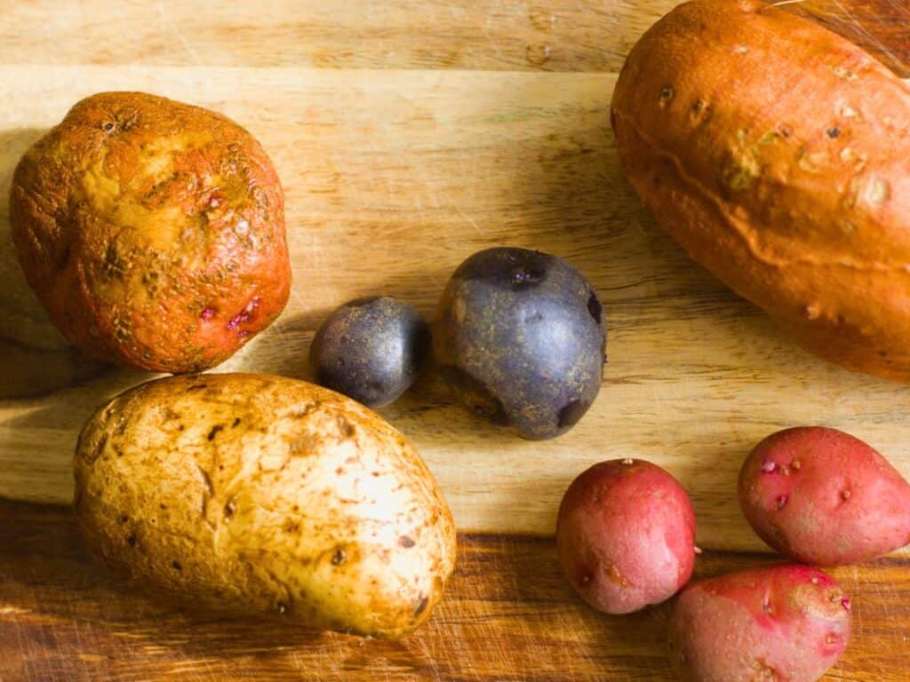different varieties of potatoes on a cutting board