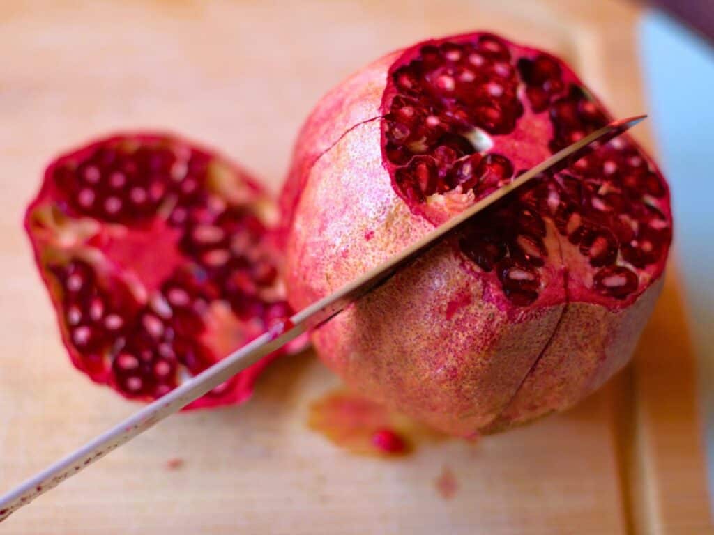 a pomegranate being cut