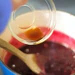 vanilla extract being added to blueberry compote