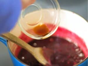 vanilla extract being added to blueberry compote