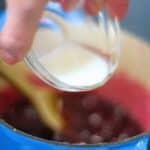 cornstarch slurry being added to blueberries