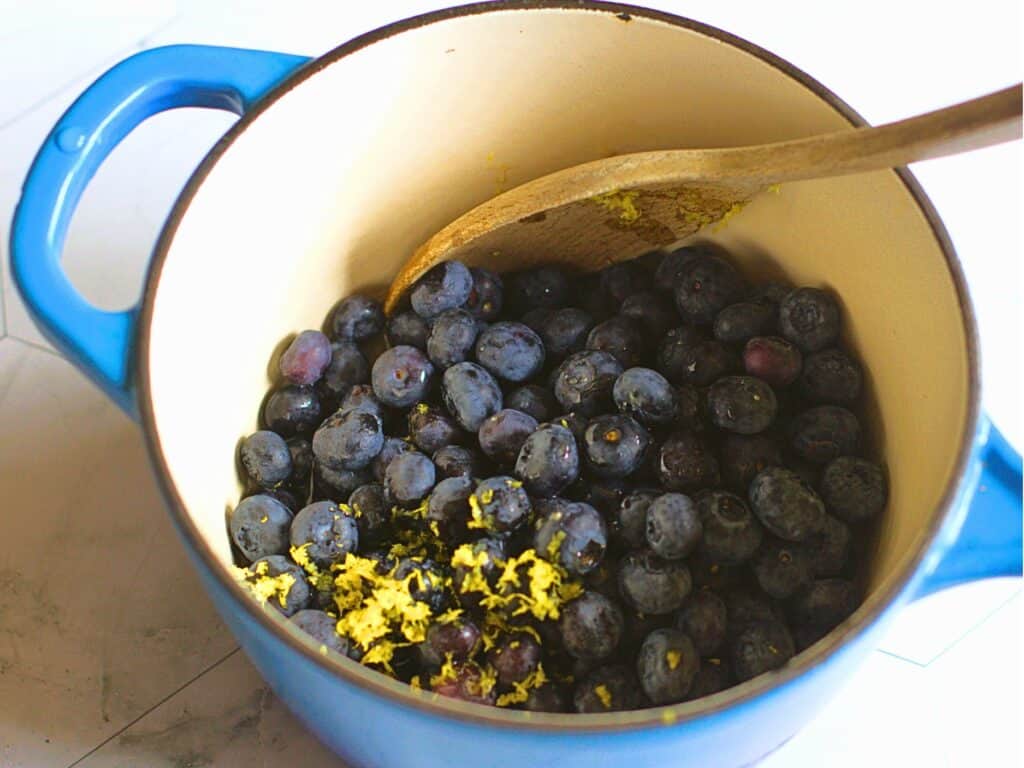 blueberries and lemon zest in a saucepan