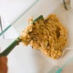 keto banana bread being added to loaf pan