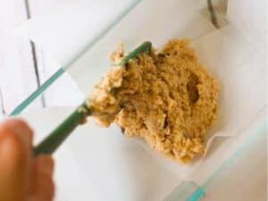 keto banana bread being added to loaf pan