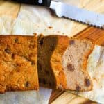 a loaf of keto banana bread sliced on a cutting board