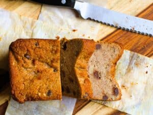 a loaf of keto banana bread sliced on a cutting board