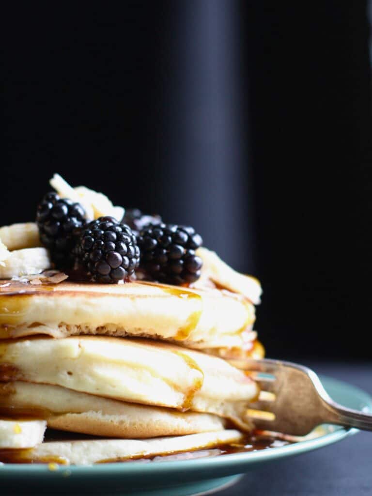 a stack of pancakes with fresh fruit