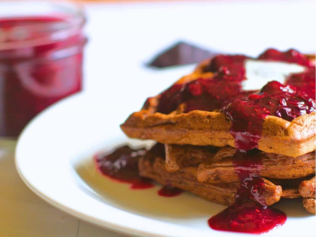 a stack of brownie waffles with blueberry compote