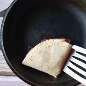 a wrap being heated in a skillet