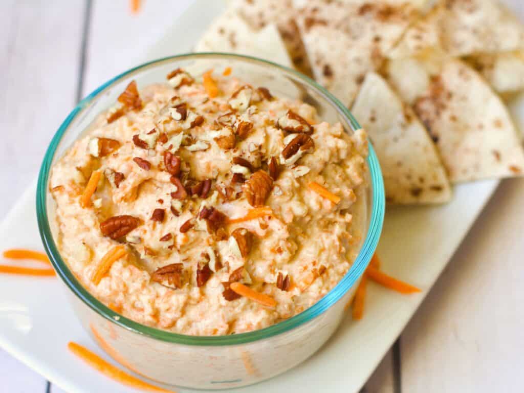 carrot cake dairy free dip in a glass dish with cinnamon tortilla chips