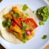 veggie fajitas on a flour tortilla with guacamole