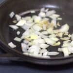 onions sauteing in a cast iron skillet