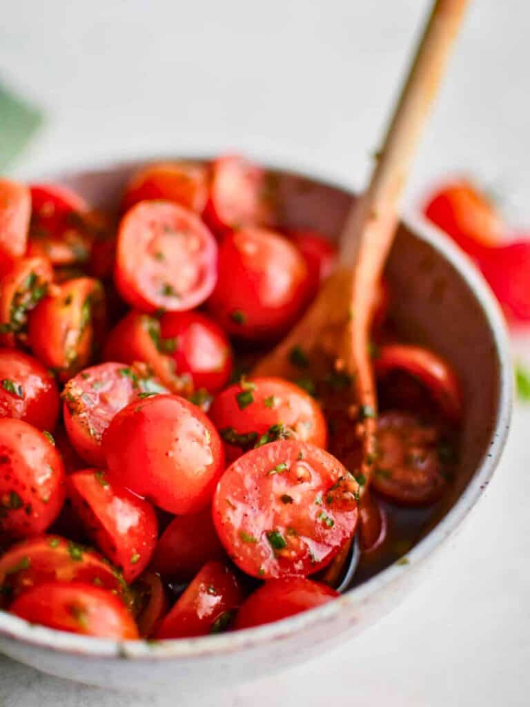 cherry tomatoes stirred with spoon