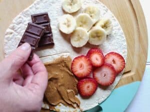 chocolate being added to a dessert wrap