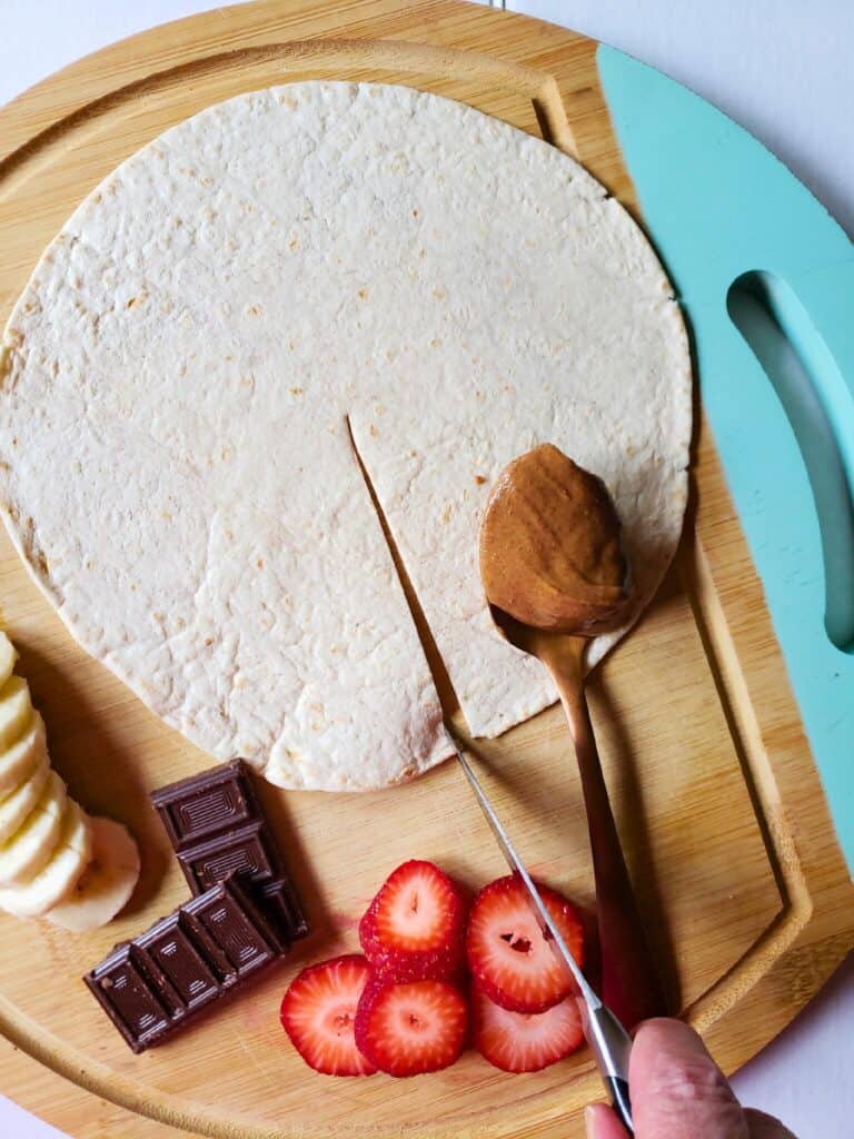 a tortilla being sliced