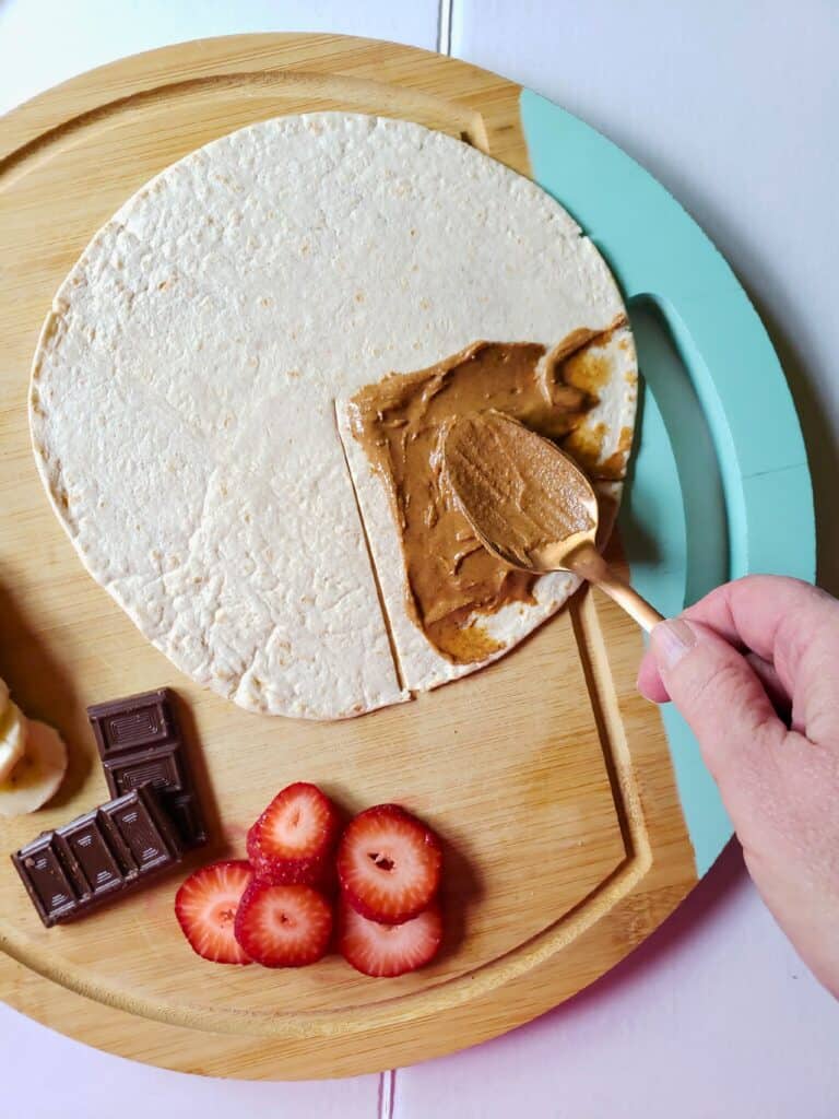peanut butter spread on a tortilla