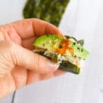 a hand holding sushi