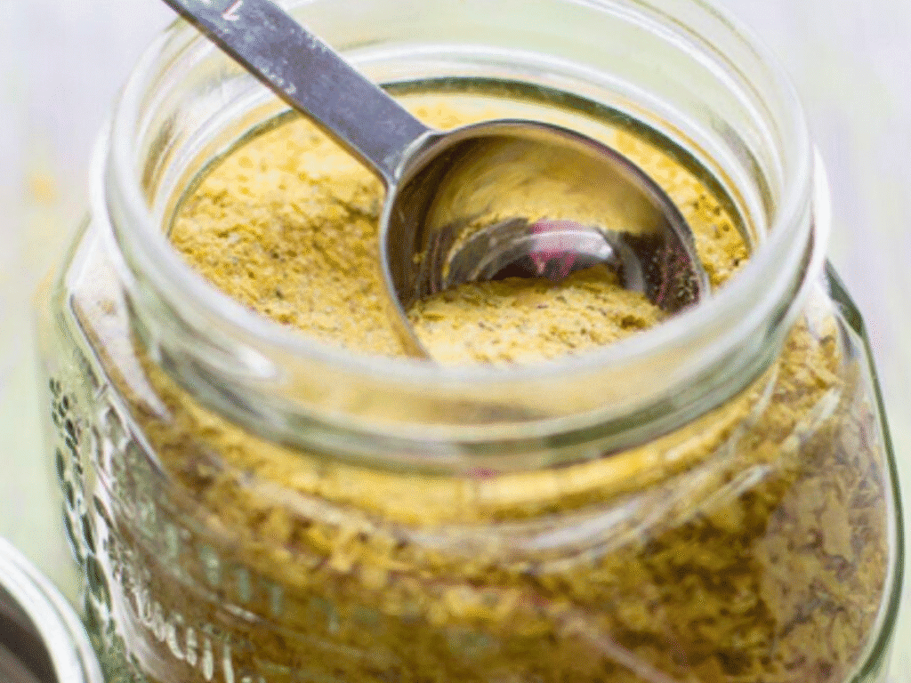 glass jar with bouillon substitute with measuring spoon