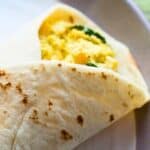a breakfast burrito filled with tofu scramble