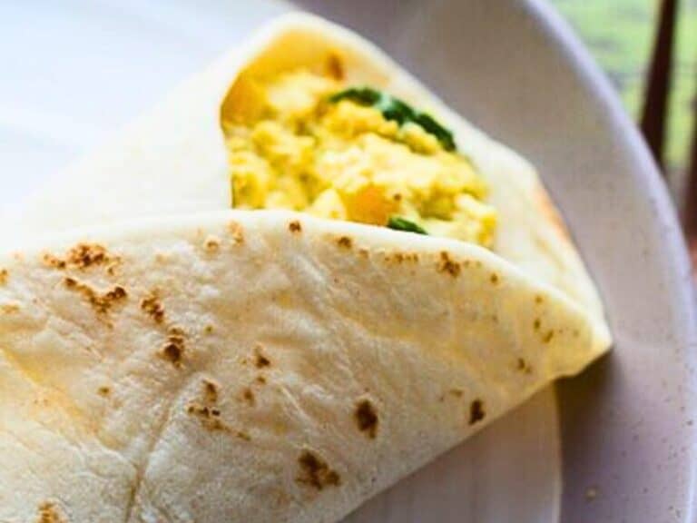 a breakfast burrito filled with tofu scramble