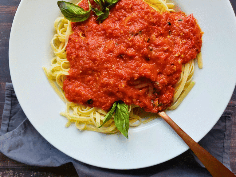 pasta sauce over a bowl of pasta