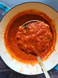 sugar free pasta sauce in a saucepan with a ladle
