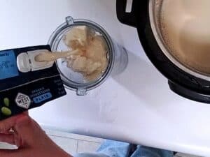 tofu and soy milk being poured into a blender