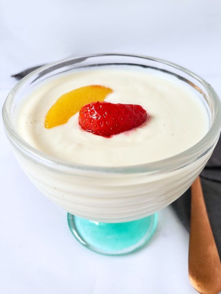 plant based yogurt and fruit in a glass cup