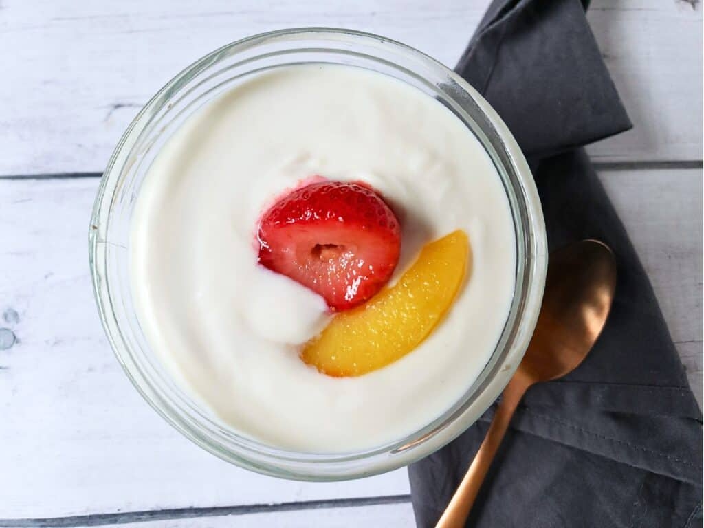 plant based yogurt in a glass dish with fruit
