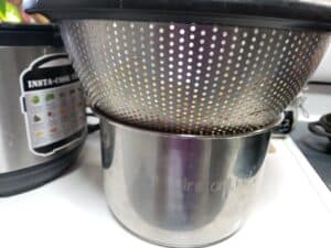 a colander on top of an instant pot insert