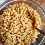 a bowl of wheat berries with a spoon