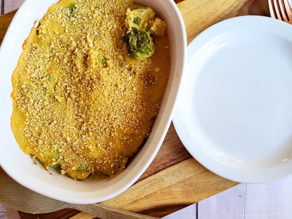 keto brussel sprouts casserole in a white dish next to a plate