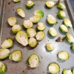 brussel sprouts spread on a baking sheet