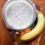 a vanilla protein shake surrounded by a banana and beans