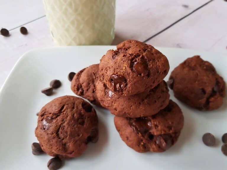 eggless cookies on a plate with a glass of soymilk