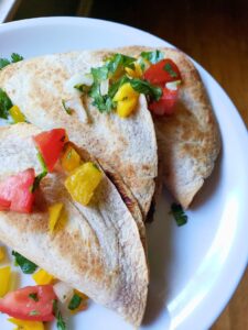 spicy potato tacos on a plate with pico de gallo
