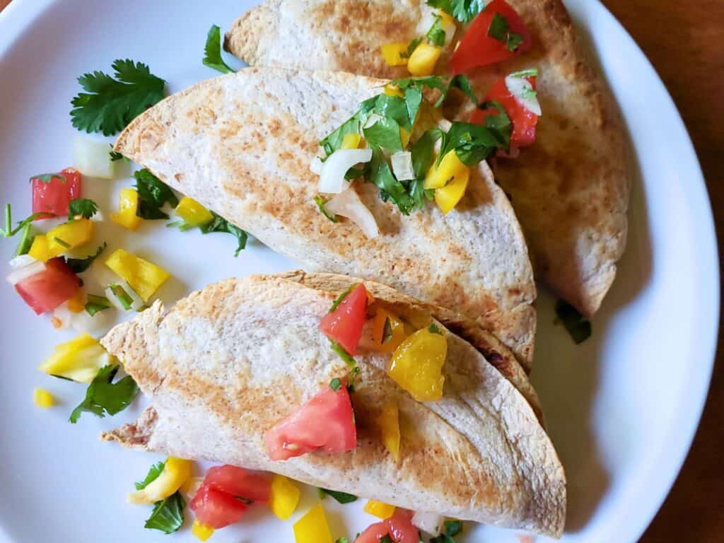 spicy potato tacos on a plate with pico de gallo