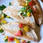 spicy potato tacos on a plate with pico de gallo